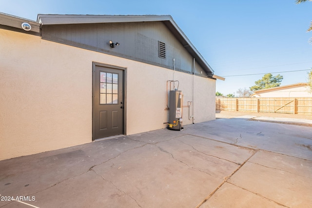 view of home's exterior with a patio area and water heater