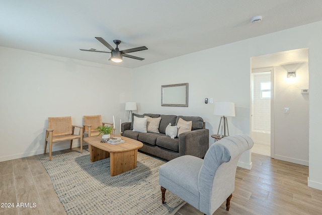 living room with ceiling fan and light hardwood / wood-style floors