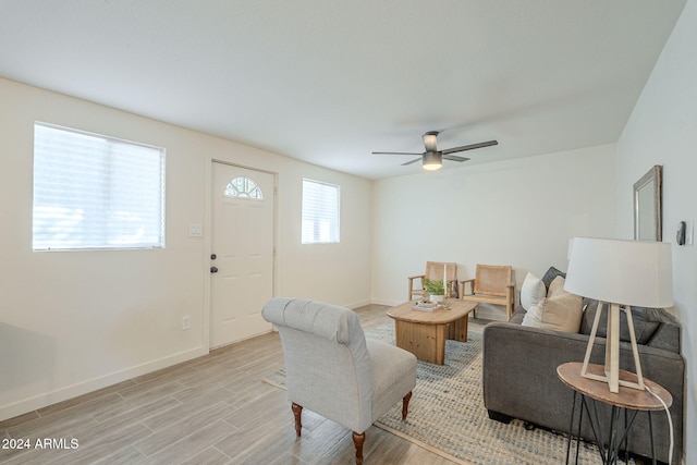 living room featuring ceiling fan and light hardwood / wood-style floors