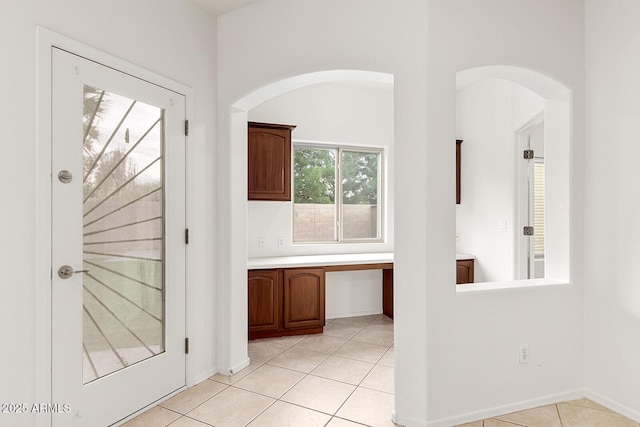 hall with light tile patterned floors