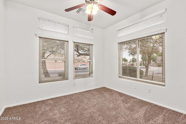 carpeted spare room with ceiling fan