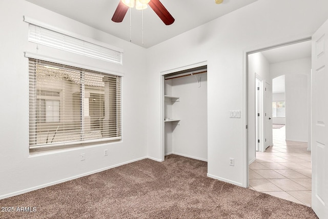 unfurnished bedroom with carpet flooring, a closet, and ceiling fan