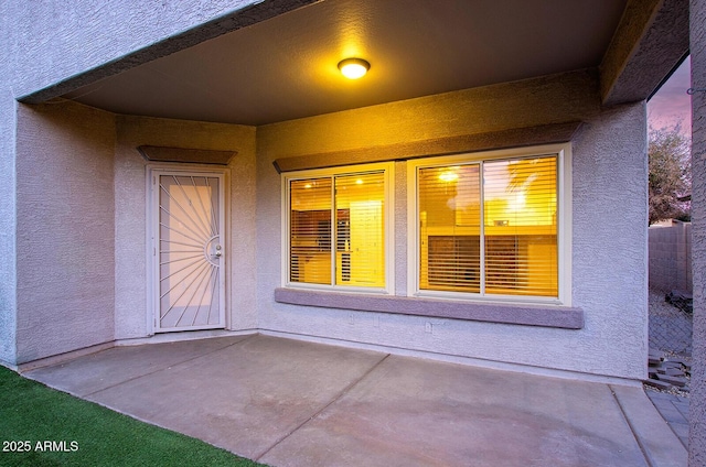 view of exterior entry featuring a patio