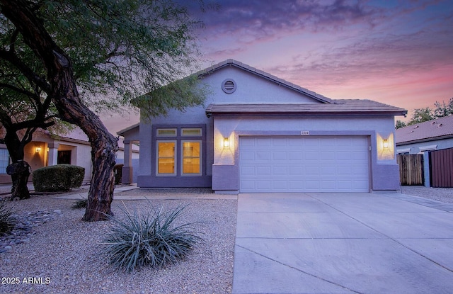 view of front of property with central AC unit and a garage