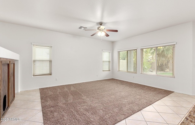 tiled spare room with ceiling fan