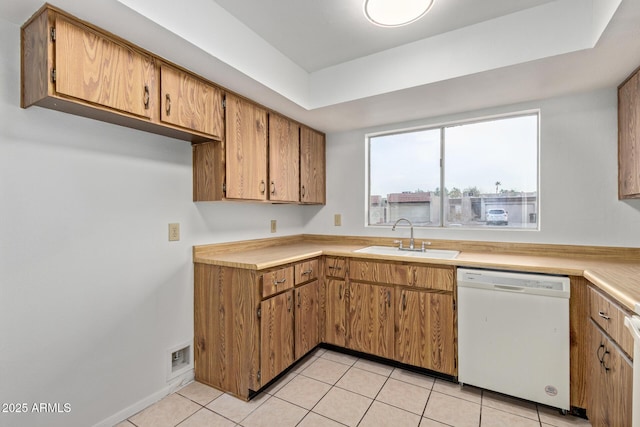 kitchen with sink, light tile patterned floors, and dishwasher