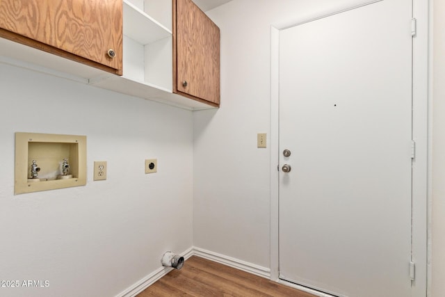 laundry area with wood-type flooring, hookup for an electric dryer, cabinets, and washer hookup