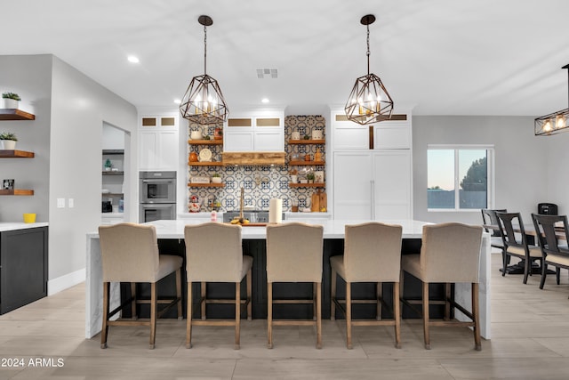 kitchen with glass insert cabinets, light countertops, white cabinetry, and open shelves