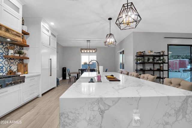 kitchen featuring hanging light fixtures, an inviting chandelier, white cabinets, and open shelves