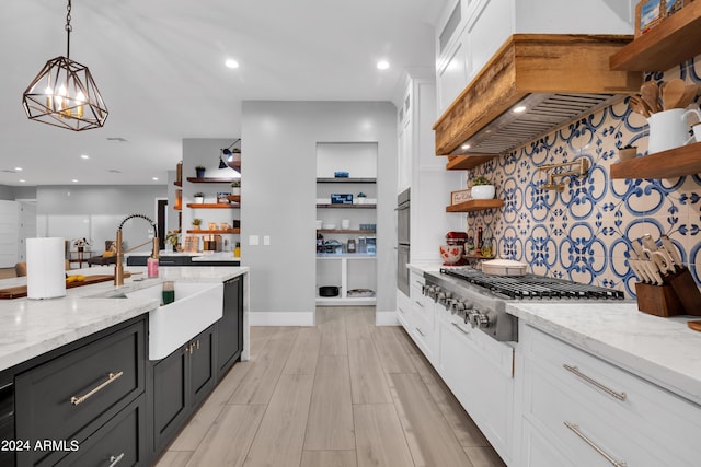 kitchen featuring white cabinets, stainless steel gas cooktop, hanging light fixtures, and open shelves