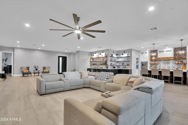 living area featuring light wood-style flooring, visible vents, and recessed lighting