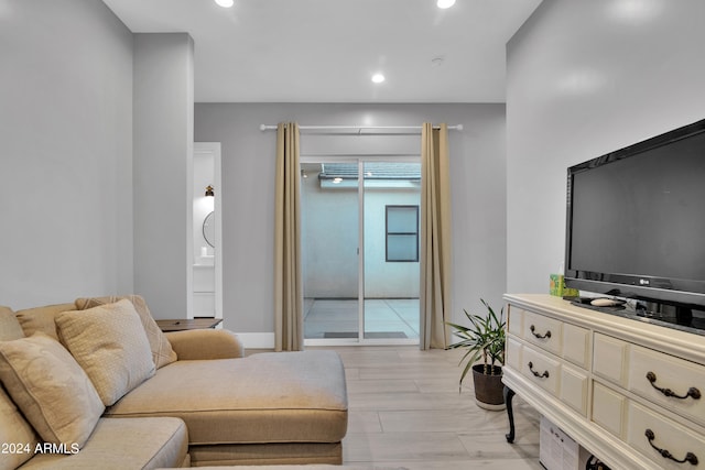 living room featuring baseboards and recessed lighting