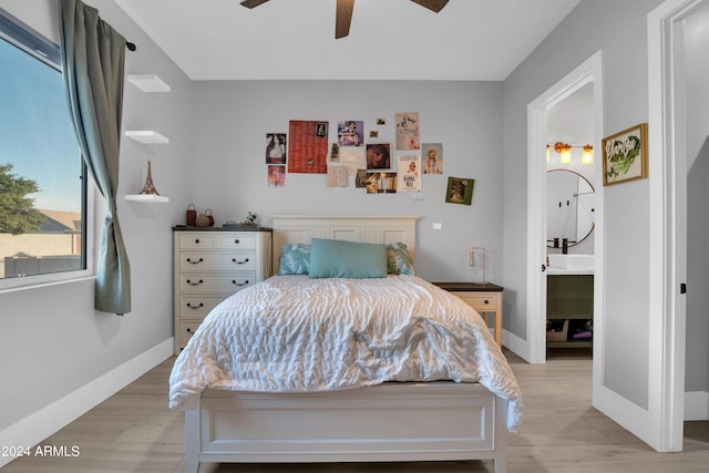 bedroom featuring a ceiling fan, light wood-style flooring, and baseboards