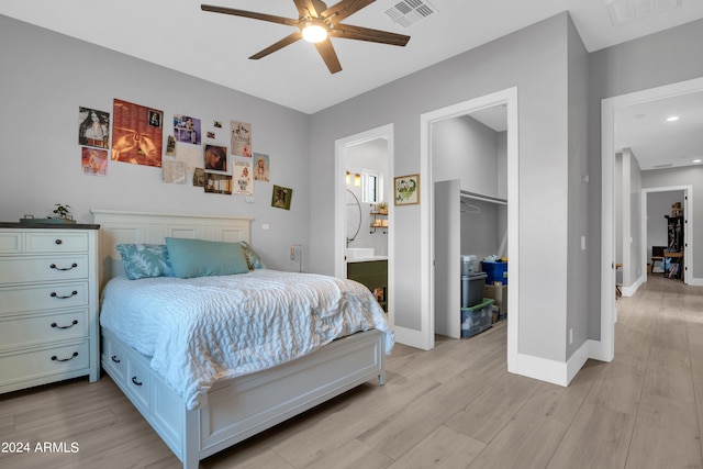 bedroom featuring light wood finished floors, baseboards, and visible vents