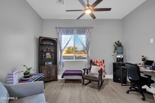 office space with light wood-type flooring, visible vents, and a ceiling fan