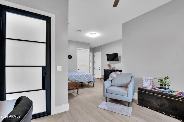 sitting room with light wood-style floors, visible vents, and baseboards