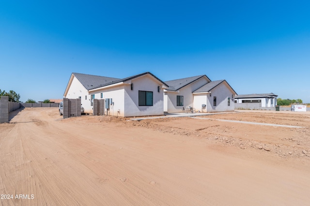 view of front of home with fence and stucco siding