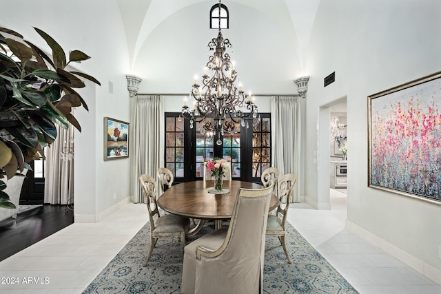 dining area with a chandelier, french doors, and light tile patterned flooring