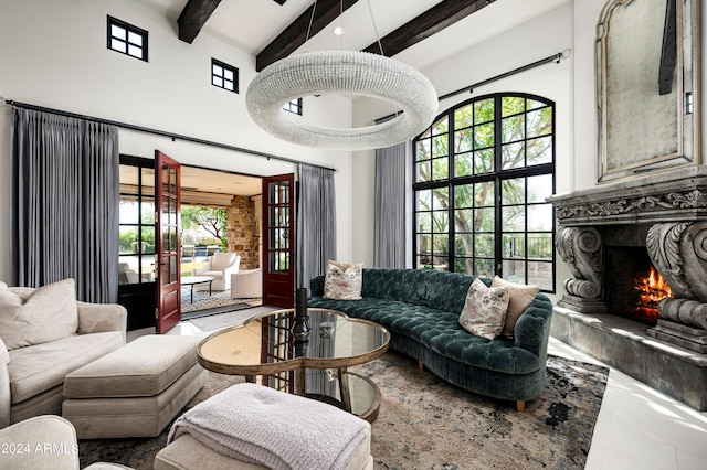 living room with a fireplace, a towering ceiling, a wealth of natural light, and tile patterned floors