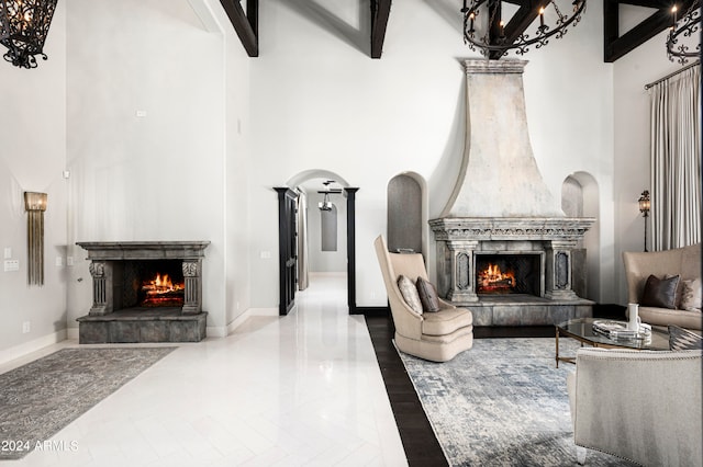 living room with a high ceiling, a high end fireplace, and beamed ceiling