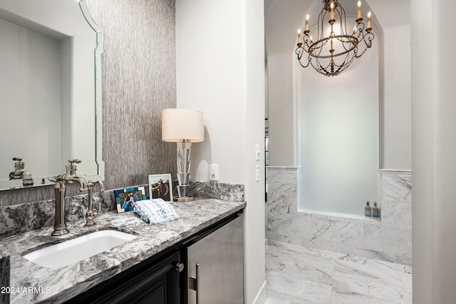 bathroom with a chandelier and vanity