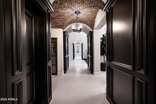 hallway with vaulted ceiling and brick ceiling