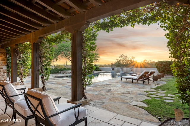 patio terrace at dusk featuring an outdoor hangout area