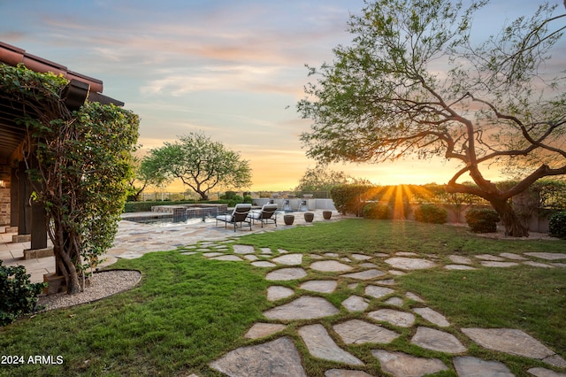 yard at dusk featuring an outdoor hangout area and a patio