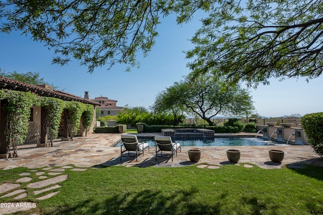 view of swimming pool with a patio area, a yard, and pool water feature