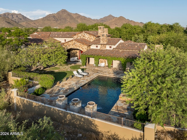 exterior space featuring a mountain view and a patio area