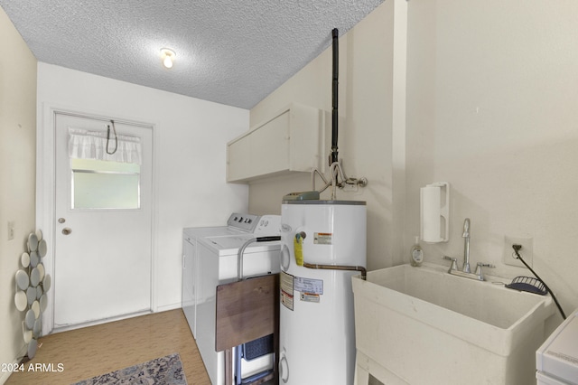 laundry room featuring sink, a textured ceiling, washer and clothes dryer, gas water heater, and light hardwood / wood-style floors