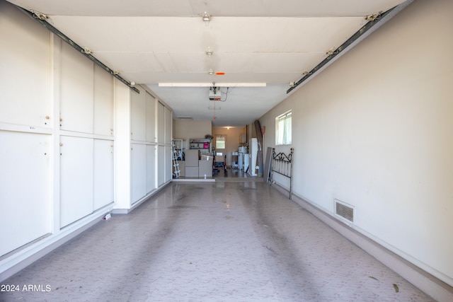 garage featuring a garage door opener and washer and dryer