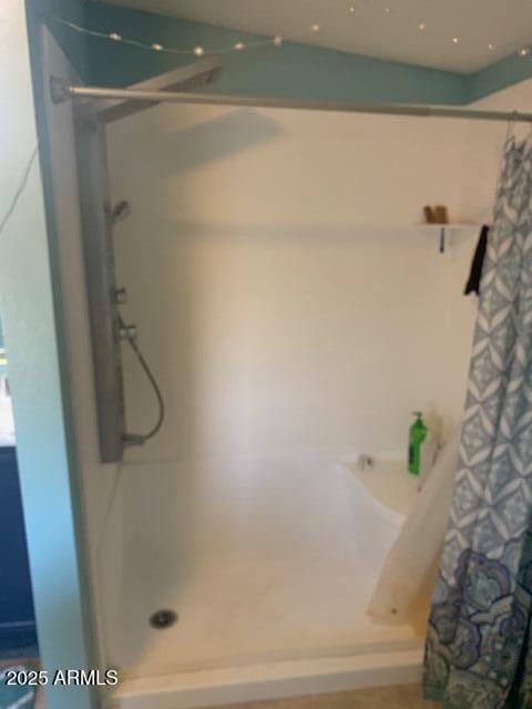full bath with a shower with shower curtain