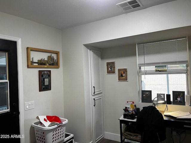 home office featuring baseboards and visible vents