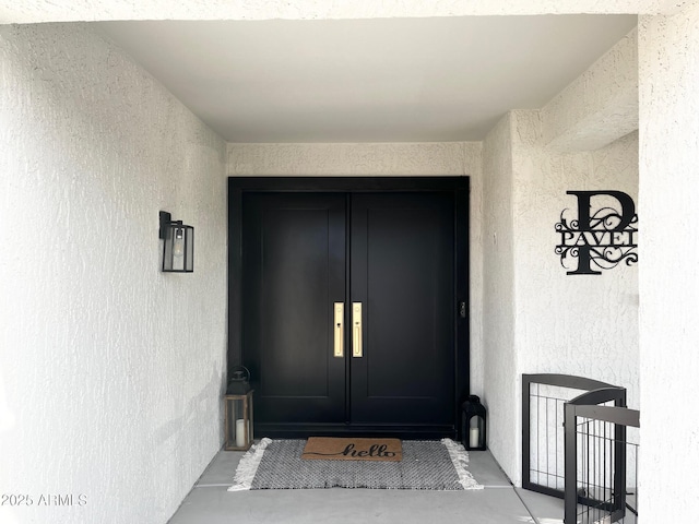 property entrance featuring french doors and stucco siding