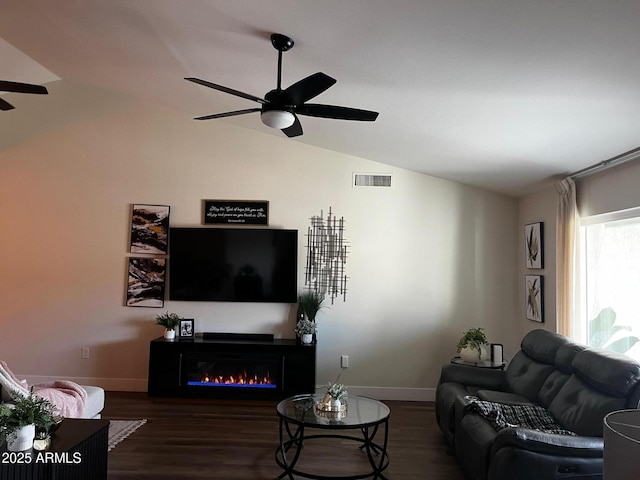 living area with a ceiling fan, baseboards, wood finished floors, vaulted ceiling, and visible vents