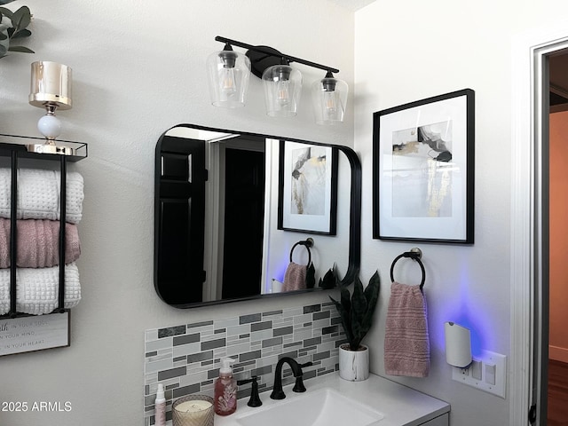 bathroom with a sink and backsplash