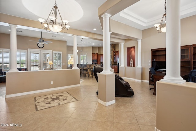 interior space with ceiling fan with notable chandelier and light tile patterned floors