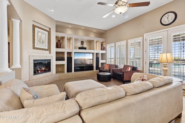 living room with decorative columns, hardwood / wood-style floors, ceiling fan, and a fireplace