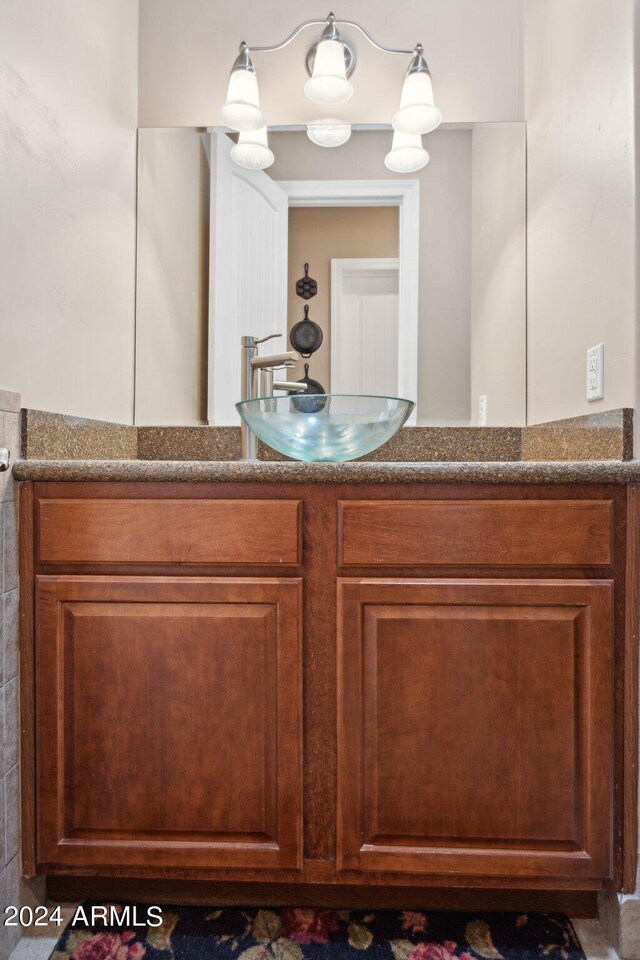 bathroom featuring vanity and a chandelier