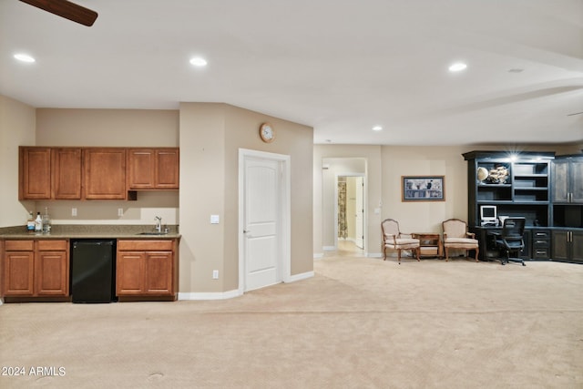 kitchen with ceiling fan, light colored carpet, and black fridge