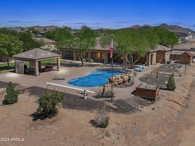 view of swimming pool with a mountain view, a gazebo, and a patio