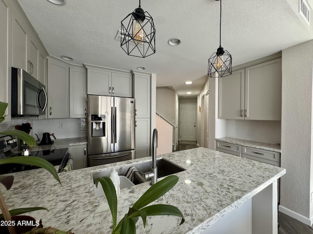 1060 E Louis Way, Tempe, AZ 85284 - kitchen featuring appliances with stainless steel finishes, a textured ceiling, light stone countertops, gray cabinetry, and recessed lighting