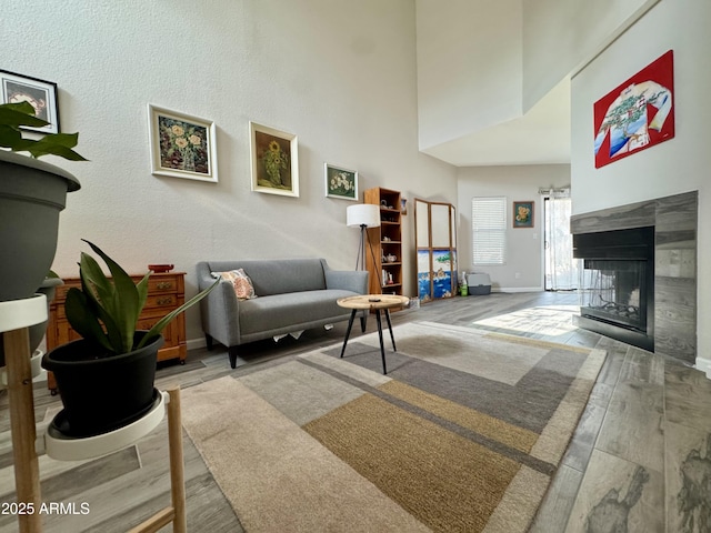 1060 E Louis Way, Tempe, AZ 85284 - living area featuring wood finished floors, a multi sided fireplace, and a towering ceiling
