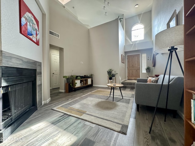 1060 E Louis Way, Tempe, AZ 85284 - living room featuring a towering ceiling, wood finished floors, and a fireplace