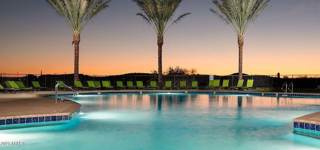 pool at dusk with a patio