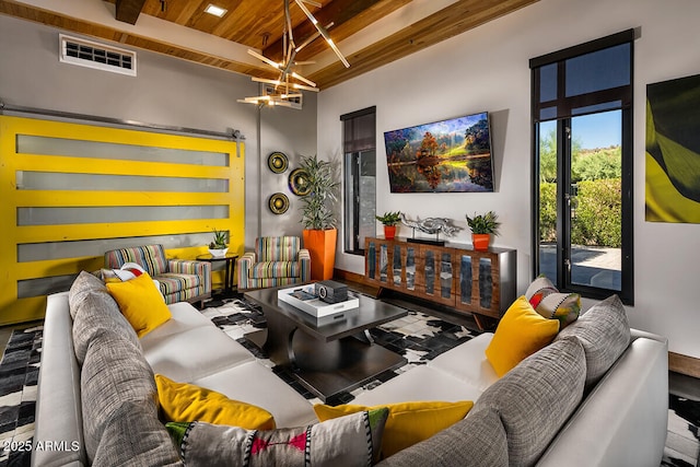 living room featuring a chandelier, beamed ceiling, and wood ceiling