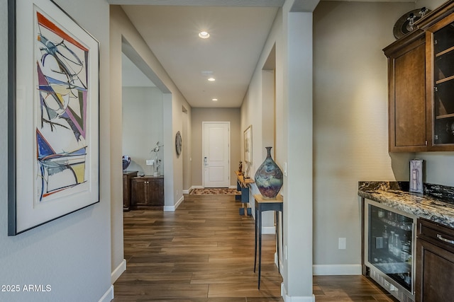 corridor with dark hardwood / wood-style floors and wine cooler