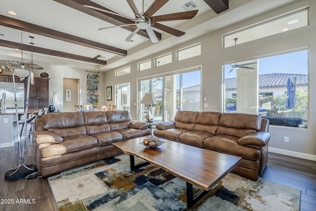 living room featuring dark hardwood / wood-style floors, beam ceiling, and ceiling fan