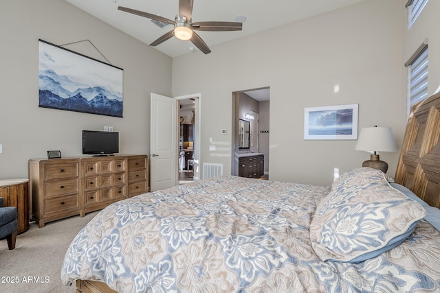 carpeted bedroom featuring ensuite bathroom and ceiling fan